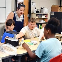Food Engineer Adventure camp participants work on assembling their aerogarden. (The Herald Bulletin photo/John P. Cleary)