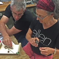 Mark French works on guitar electronics with a Pennsbury High School teacher in Fairless Hills, Pennsylvania