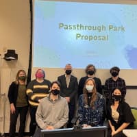 Four Purdue Polytechnic students presented proposals for the Passthrough Park that runs between East Main Street and Jack Elstro Plaza. Those attending the presentations included Sarah George (back row, from left), an associate professor of practice; student Addie Rose; Mayor Dave Snow; student Ethan Clark; student Matthew Wair; Ian Vanness (front, from left), city director of infrastructure and development; student Kaitlyn Jurgens; and Denise Retz, park superintendent. (Photo/Richmond Parks and Recreation)