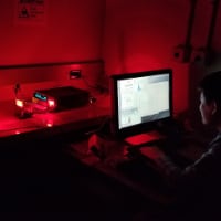 Purdue University graduate student Xiaozhe Fan measures how much light is emitted by a GaAs solar cell. The light emitted by the solar cell is modulated to convey information. (Image provided)