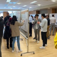 Students, faculty and staff discuss Purdue Polytechnic research projects in Stewart Center.