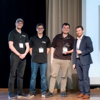 Uniform Sierra Aerospace participated in the biannual Black and Gold Awards pitch competition. Purdue Innovates Startup Foundry, led by Tyler Mantel (far right), awarded $100,000 to the company founded by Jeremy Fredrick (far left), Trevor Redpath (center left) and Duncan Mulgrew (center right). (Photo credit: Vincent Walter)