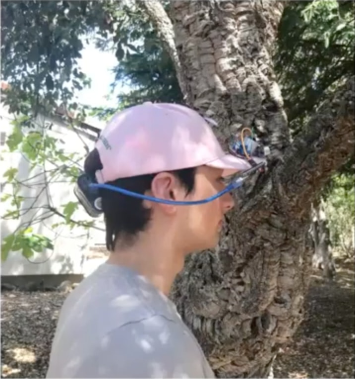 A student demonstrates "Helpful Headgear," an electronic sensor that alerts sight-impaired wearers of approaching hazards.