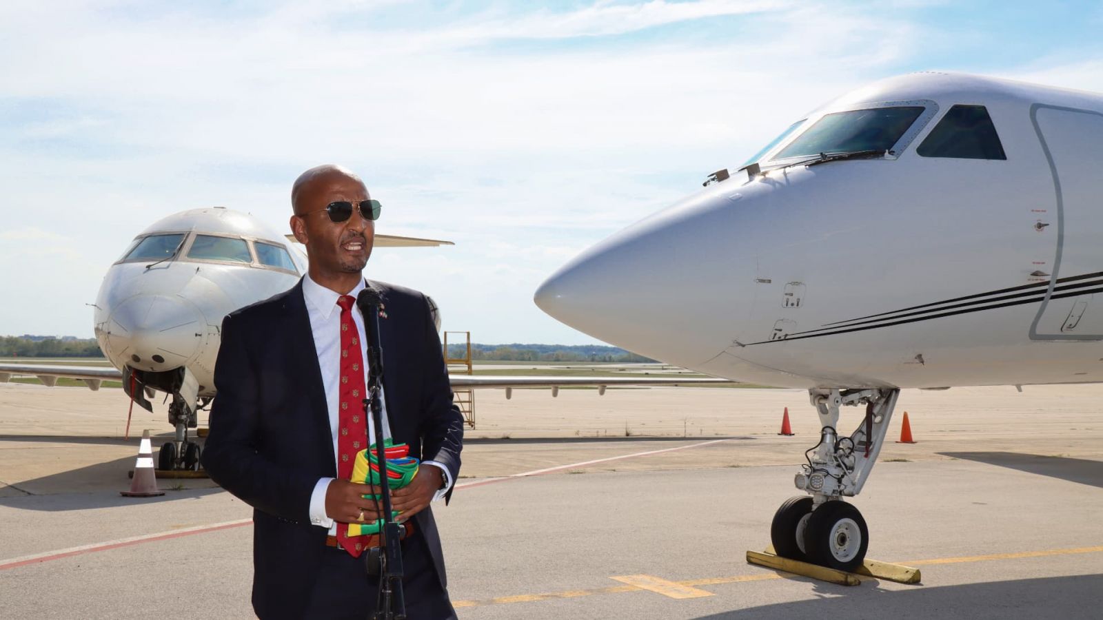 Dawit Lemma (ASc aeronautical engineering technology & flight technology '02), founder and CEO of Krimson Aviation, prepares to present the Ethiopian national flag for Purdue's Niswonger Aviation Technology Building in commemoration of Krimson Aviation's new scholarship. (Purdue University photo/John O'Malley) (Download full-size photo in the Media Kit, below.)