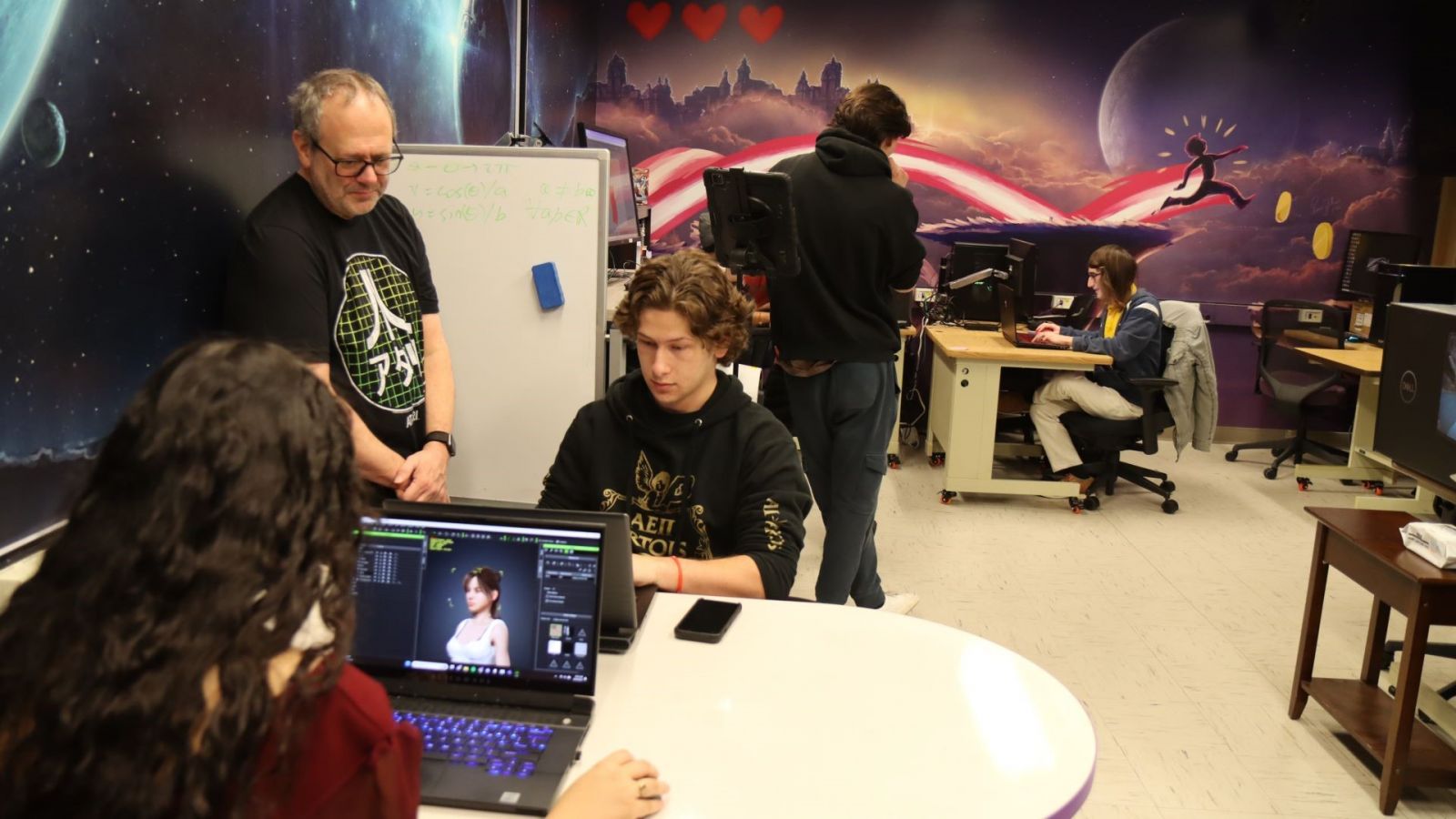 Students work with CGT faculty member David Whittinghill (left) in the Games Innovation Laboratory. (Purdue University photo/John O'Malley)