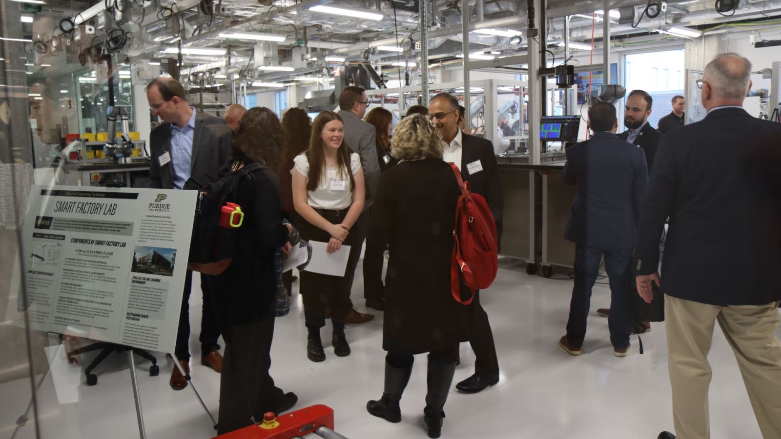 People gathered in the Smart Learning Factory, one of four new student-focused labs in the School of Engineering Technology, during the dedication on November 30. (Purdue University photo/Zach Rodimel)