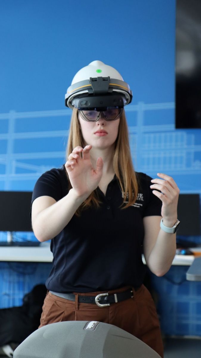 Sally Jones, senior, demonstrates her capstone with Trimble-provided Hololens and software. (Purdue University photo/Zach Rodimel)