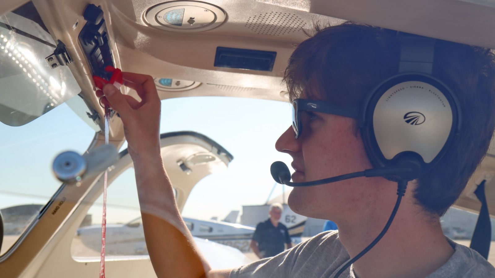 Luca Capecchi, a first-year student majoring in professional flight, demonstrates using the magneto safety guard in the flight deck of a Piper Archer aircraft at Purdue University Airport. The patented magneto safety guard was designed by aviation experts in the School of Aviation and Transportation Technology. (Purdue University photo/John O’Malley)