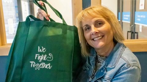 Julie LaGrange holds up a We Fight Together care package (Purdue University photo/Alison Manges)