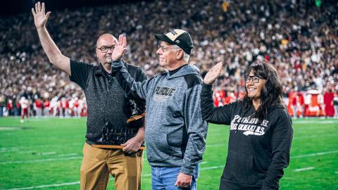 Matt Folk honored John Cox and Antonia Munguia as recipients of the 2022 Special Boilermaker Award during the Purdue vs. Nebraska game on Oct. 15. (Purdue Athletics)